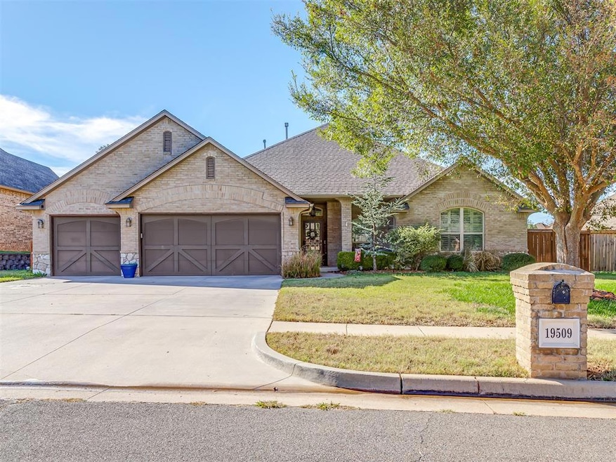 Single story home featuring a garage and a front y