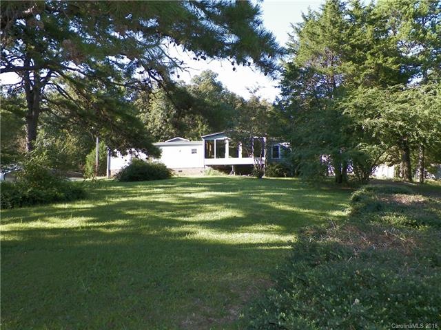 FRONT OF THE HOME; BEAUTIFUL SLOPING LOT WITH SHAD