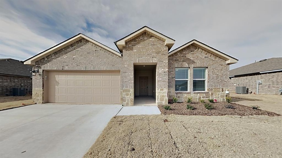 View of front of property featuring a garage and c
