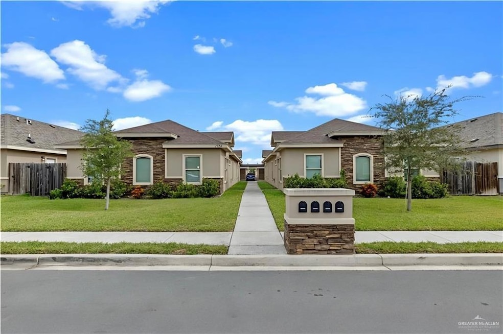 View of front of home featuring stone siding and stucco siding