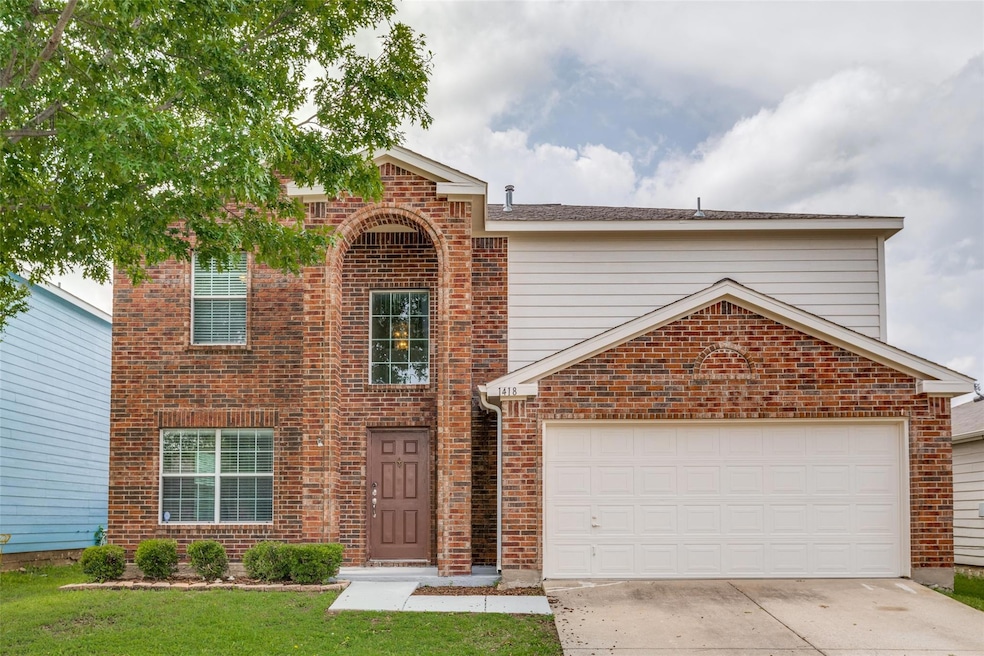 Front of property featuring a garage and a front yard