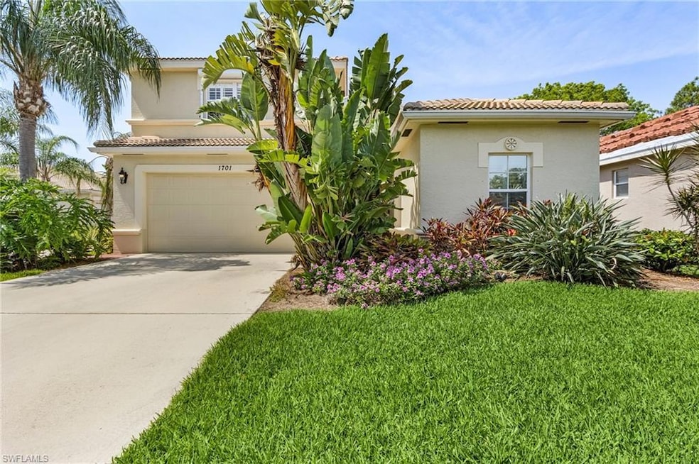 Mediterranean / spanish home with a garage and a f
