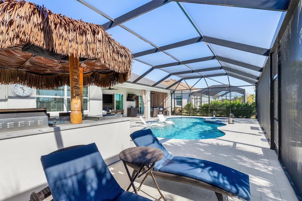 Very spacious screened lanai runs the entire width of the house with saltwater pool, spa and tiki hut!