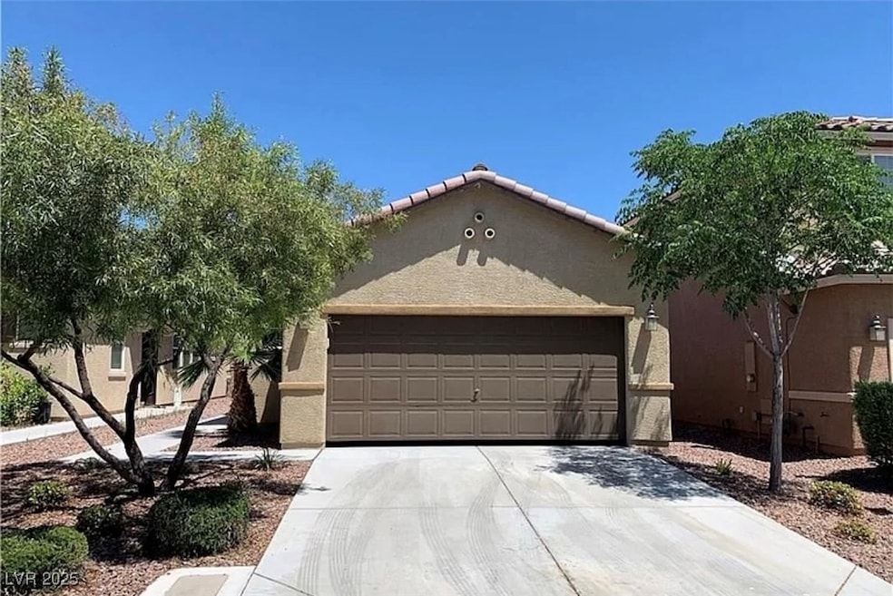 View of front of property with stucco siding, conc
