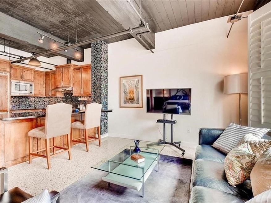 Living room with dark aggregate flooring and rail