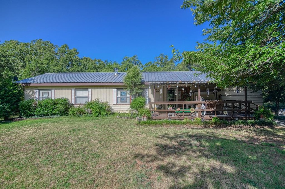 Rear view of house with a lawn