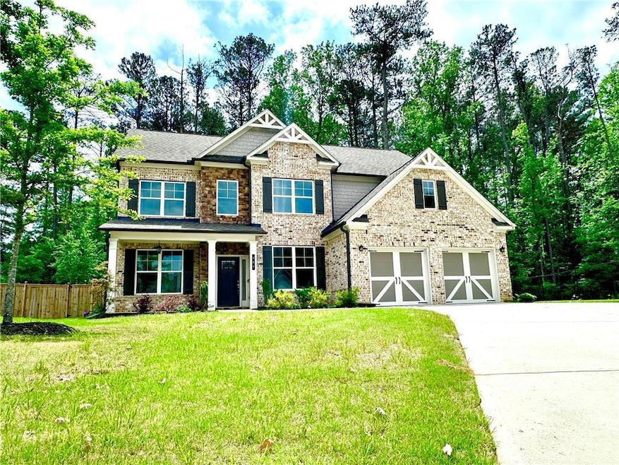 Craftsman-style house with brick siding, fence, a 
