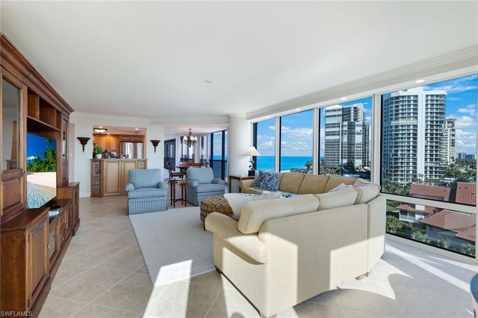 Tiled living room featuring a water view, expansiv