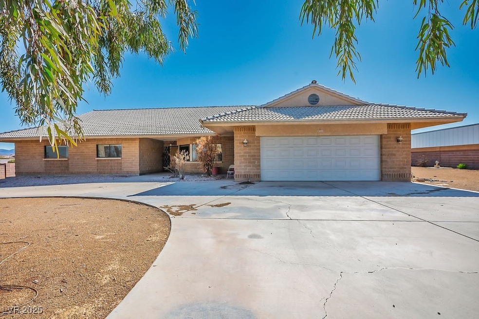 Ranch-style home featuring a garage, concrete driv