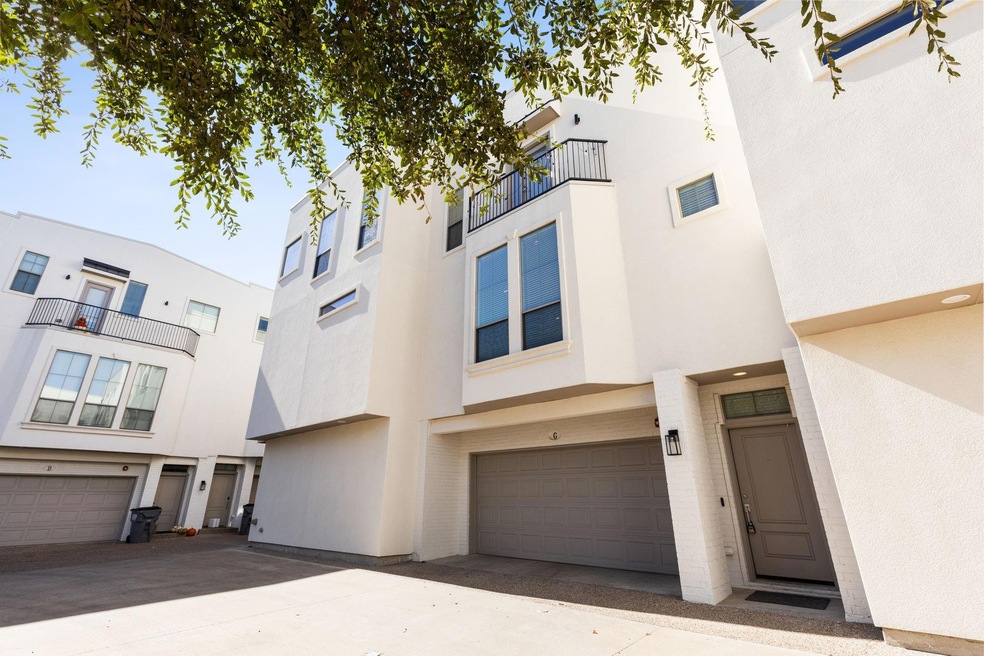 View of property with a balcony and a garage