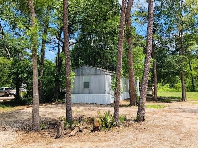 The Singlewide on the left side of the fence is included