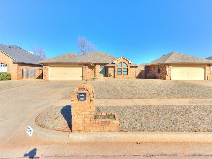 Ranch-style home featuring fence, driveway, a gara