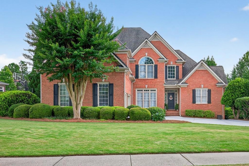View of front of home with brick siding and a front lawn