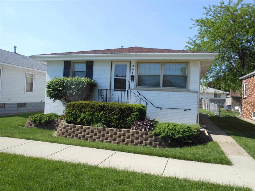 Front of vinyl sided home features a raised stoop 