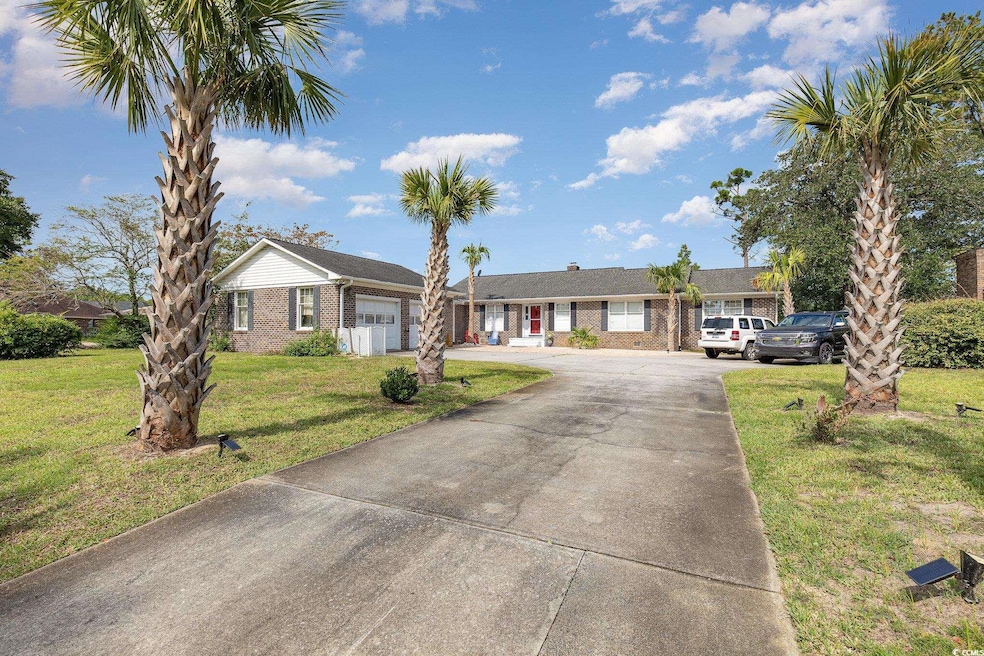 Single story home with a garage and a front lawn