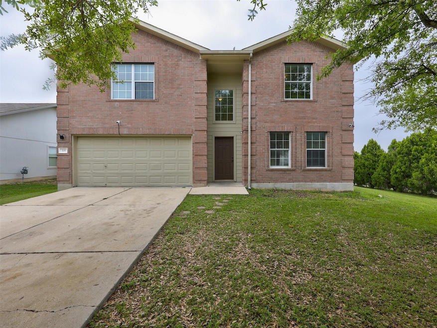 View of front of home with brick siding, concrete