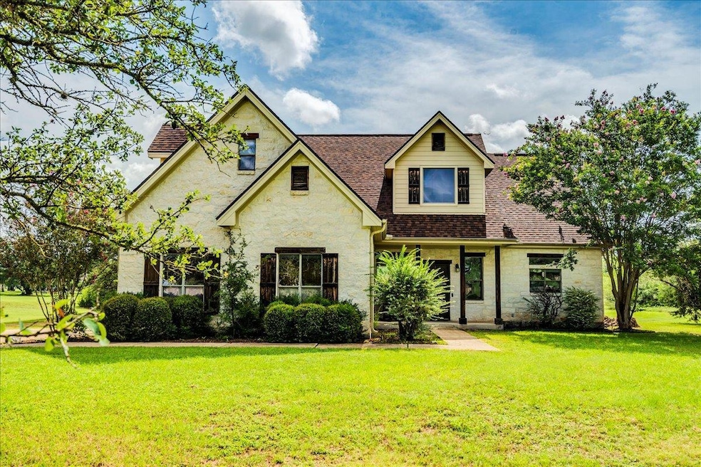 View of front of home with stone siding, a front 