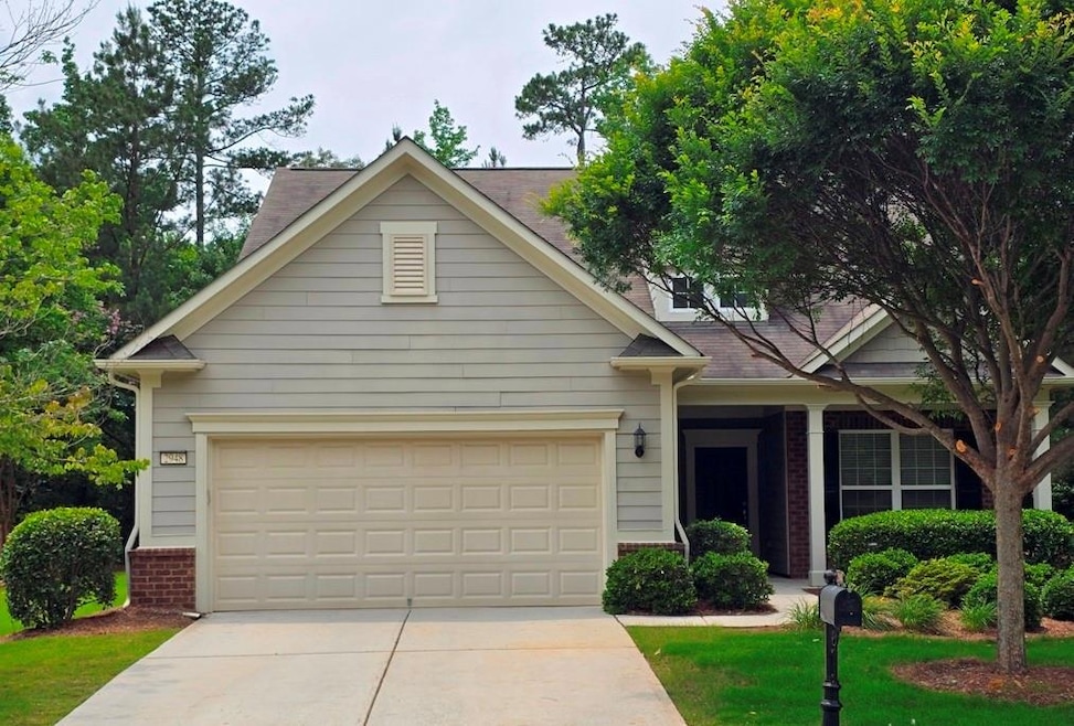 View of front facade with concrete driveway, brick siding, and a garage