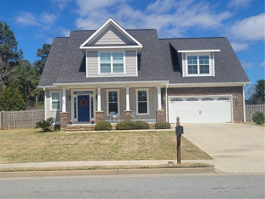 Craftsman-style home with a front lawn, a porch, f