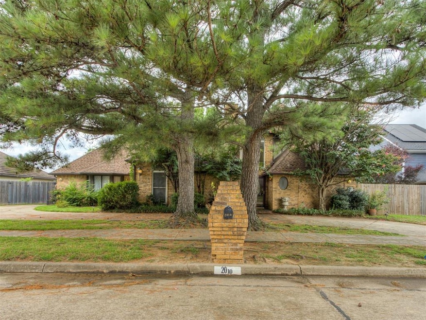 View of front facade featuring brick siding and roof with shingles