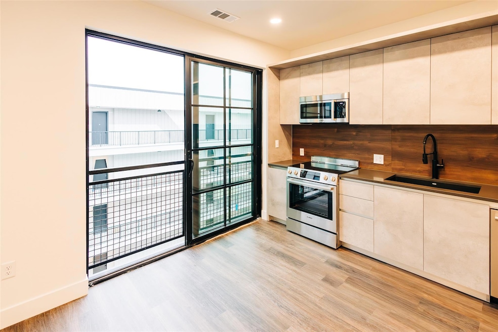 Kitchen featuring light wood-style floors, applia