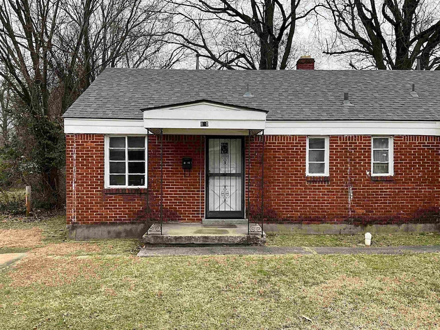 View of front of home with brick siding, a chimney