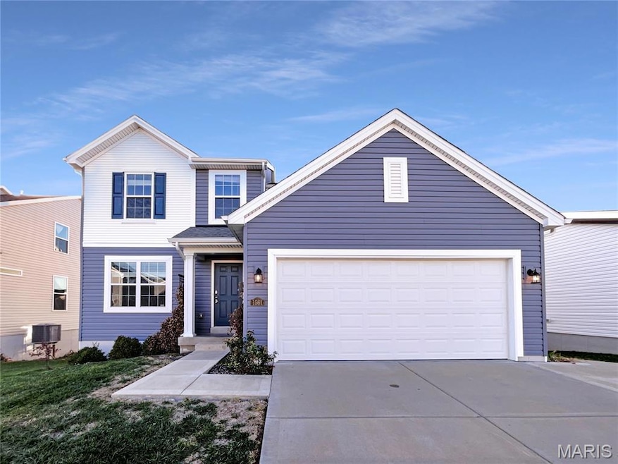 Traditional home with driveway and an attached garage