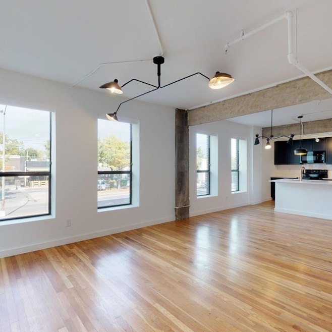 Unfurnished living room featuring sink and light h
