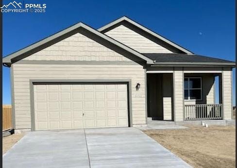 Single story home with concrete driveway and an attached garage