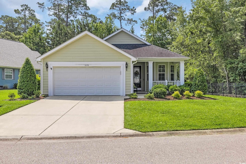 Ranch-style house featuring covered porch, driveway, an attached garage, and a shingled roof