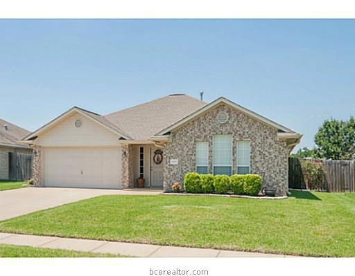 Exterior Front. Stone-lined flowerbeds and a manicured lawn complement the exterior of this home.