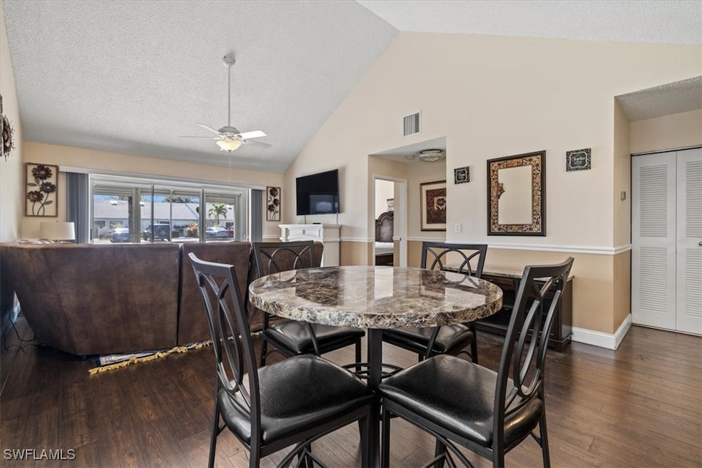 Dining space featuring ceiling fan, dark hardwood