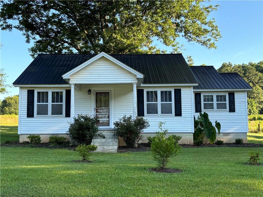 View of front with a front lawn, large front porch