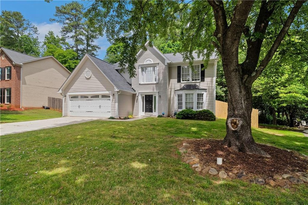 Traditional-style house with a garage and concrete driveway