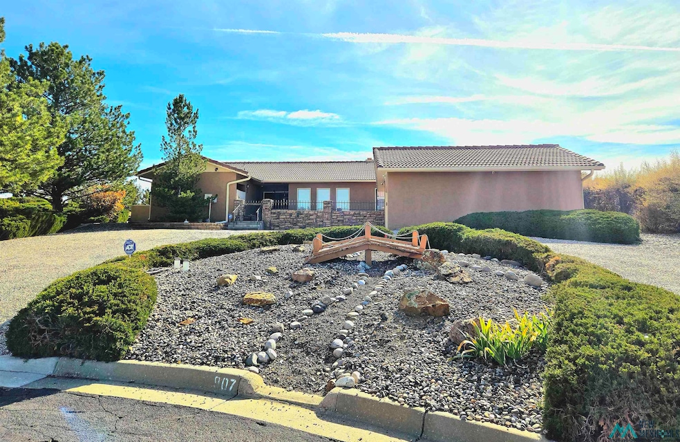 View of front of property featuring stucco siding, a tiled roof, and stone siding