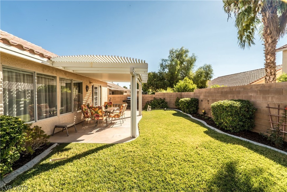 Fabulous backyard with lush green grass and covere