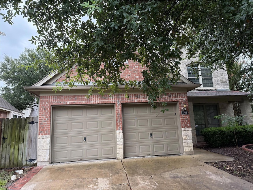 View of front facade featuring brick siding, driv
