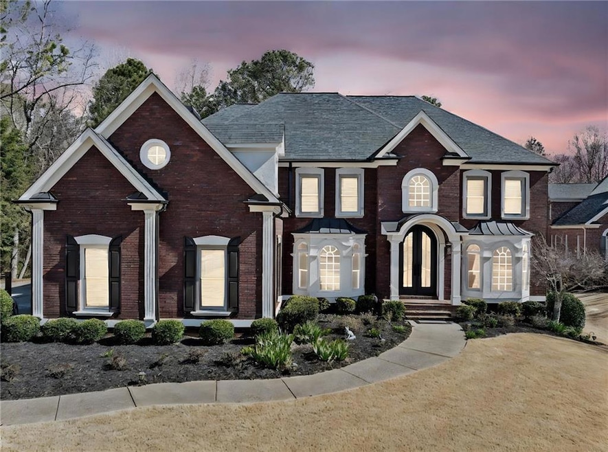 View of front of house with brick siding and roof 