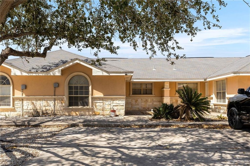 View of front of home featuring stone siding and stucco siding