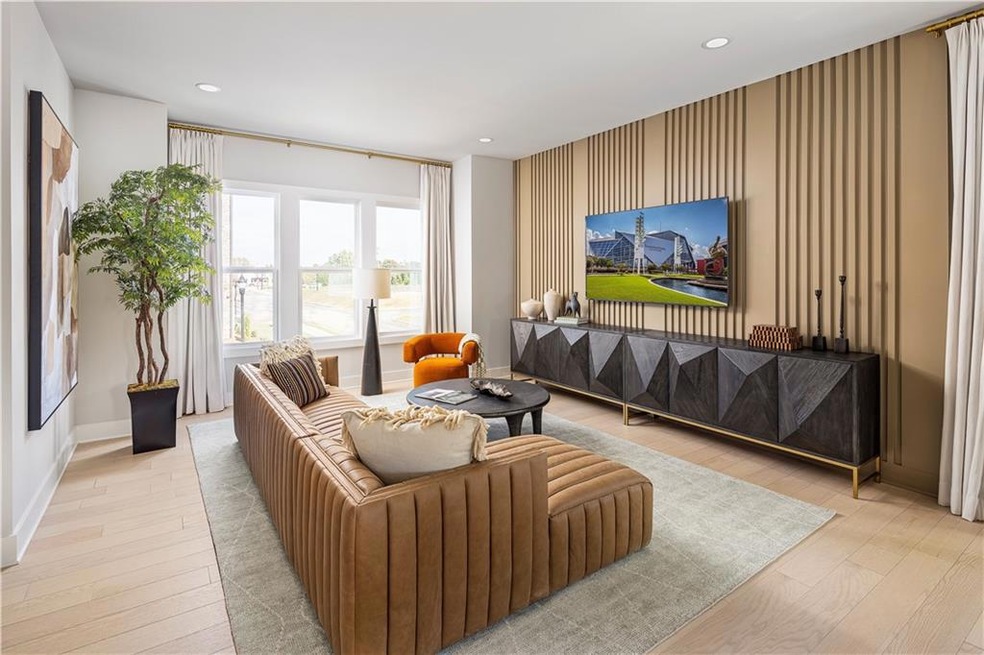 Living area featuring an accent wall, recessed lig