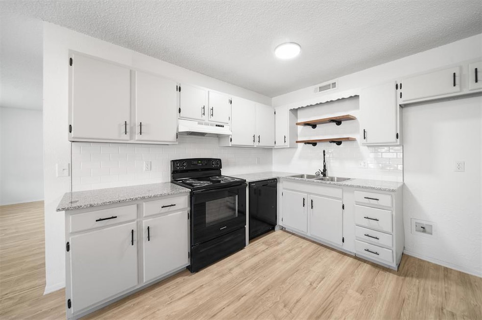 Large kitchen featuring new stove, sink, and faucet