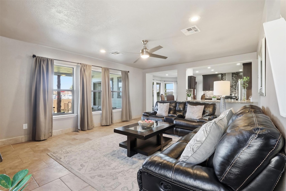 Living area with a ceiling fan and recessed light
