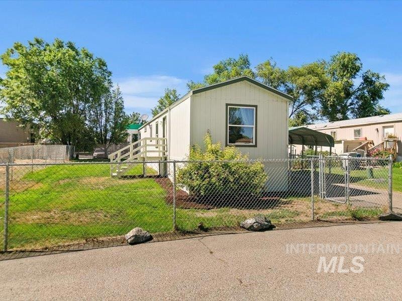 View of side of property with a detached carport