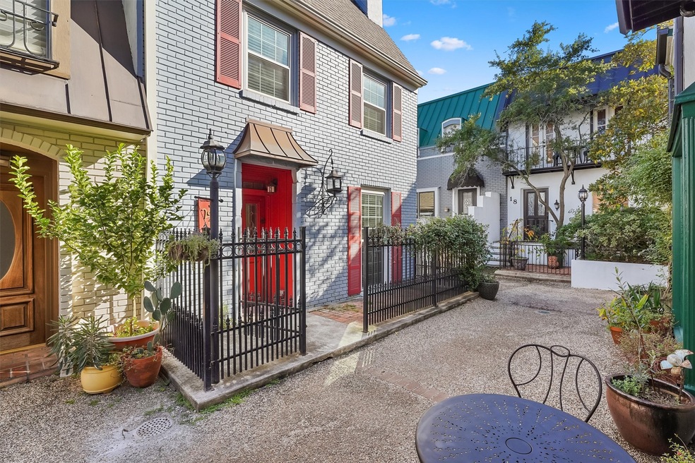French style townhouse with front fenced-in patio.