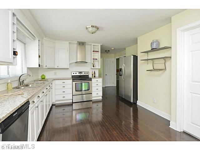 Kitchen. Natural light floods this space. Pewter hardware, granite counters, undermount ss sink. Wine racks, cookbook bookcase, euro vent hood, radiant top ss range. Stainless steel high end dishwasher w interior ss tub. SS Fridge with ice & water.