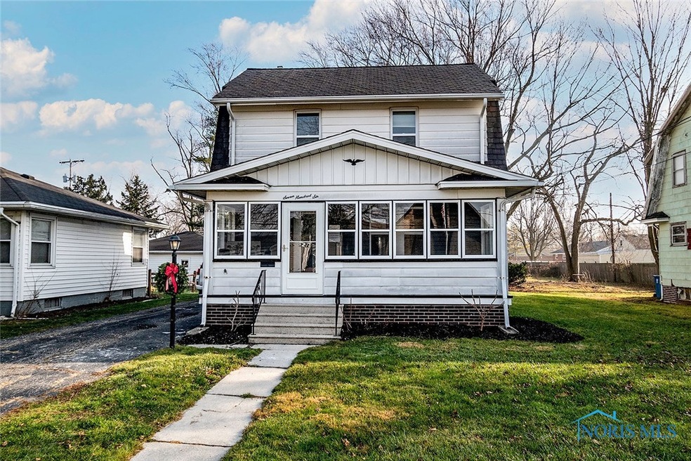 Front of home, detached garage in back to the left