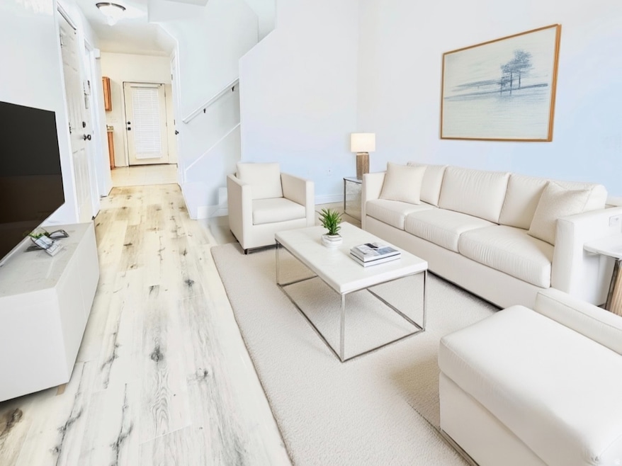 Living area featuring light wood-style flooring and a ceiling fan