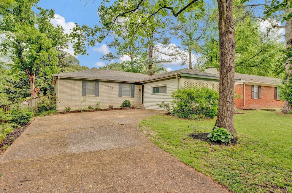 Single story home featuring brick siding, driveway