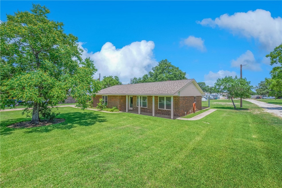 Ranch-style house with brick siding and a front ya