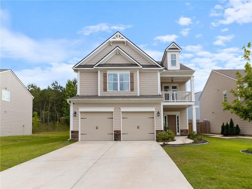 Craftsman-style home featuring a garage, a front y